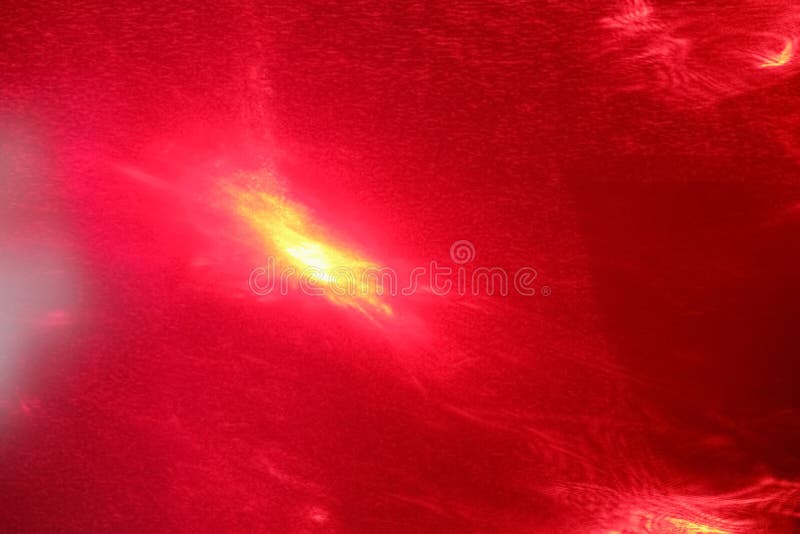 Abstract photophone painted with a red laser as a result of light refraction. Place for text