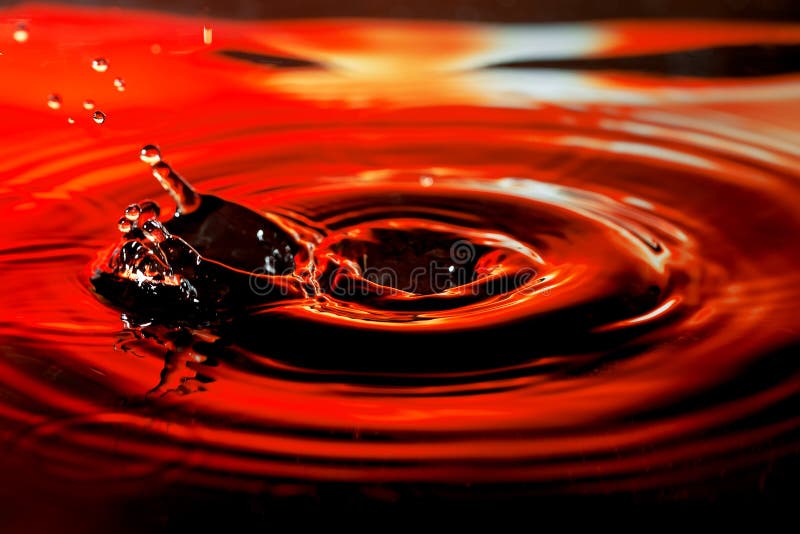 Abstract picture of water drop with splash and ripples on nice red orange background royalty free stock images Abstract picture of water drop with splash and ripples on nice red orange background royalty free stock images