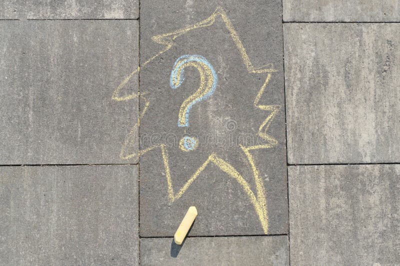 Abstract question mark drawn in crayons on gray asphalt stock photo