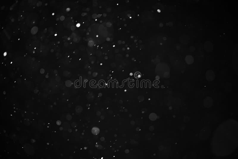 Abstract real dust floating over black background for overlay royalty free stock images