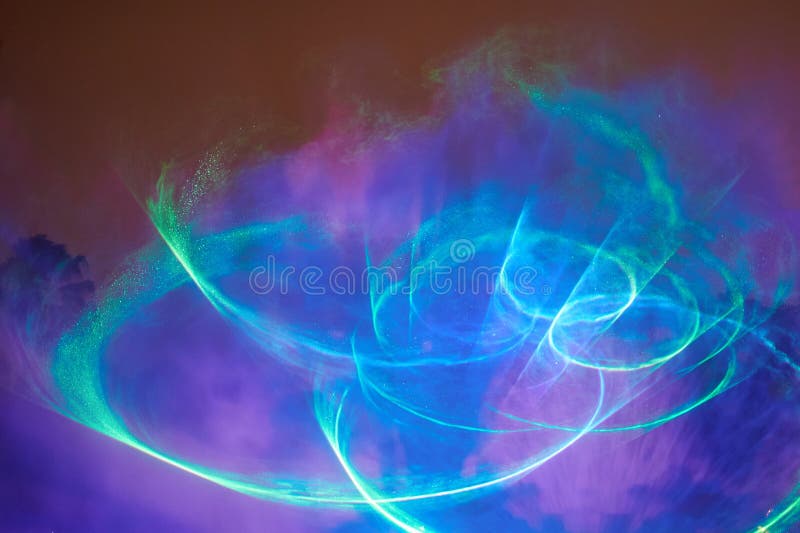 Abstract round laser show. Blue and green laser rays. Disco club illumination