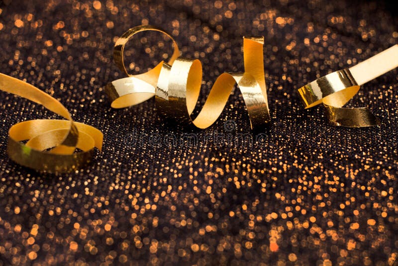 Abstract, shiny holiday background. Gold bow on black shiny background. Background package pattern stock images, royalty-free photos and pictures