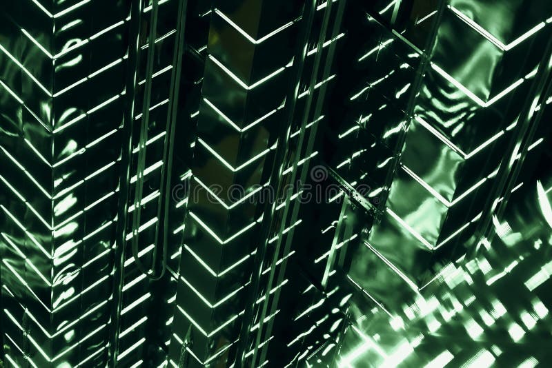 Abstract skyscraper at night, dark neon fluorescent wall of building in green color, neon lights