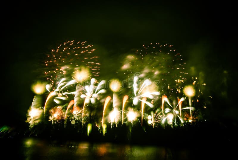 Abstract style colorful photo of fireworks in a green tone. Artistic, blurry, colorful look.