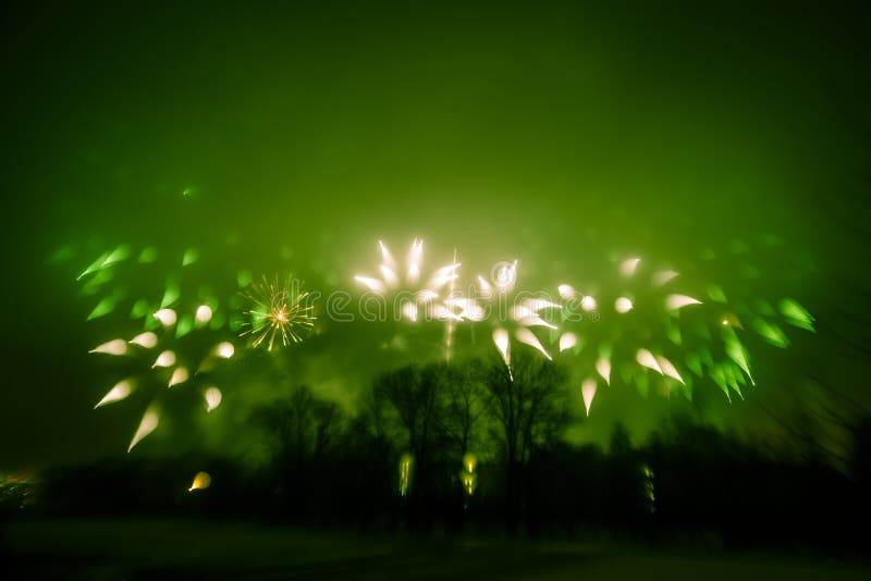 Abstract style colorful photo of fireworks in a green tone. Artistic, blurry, colorful look.