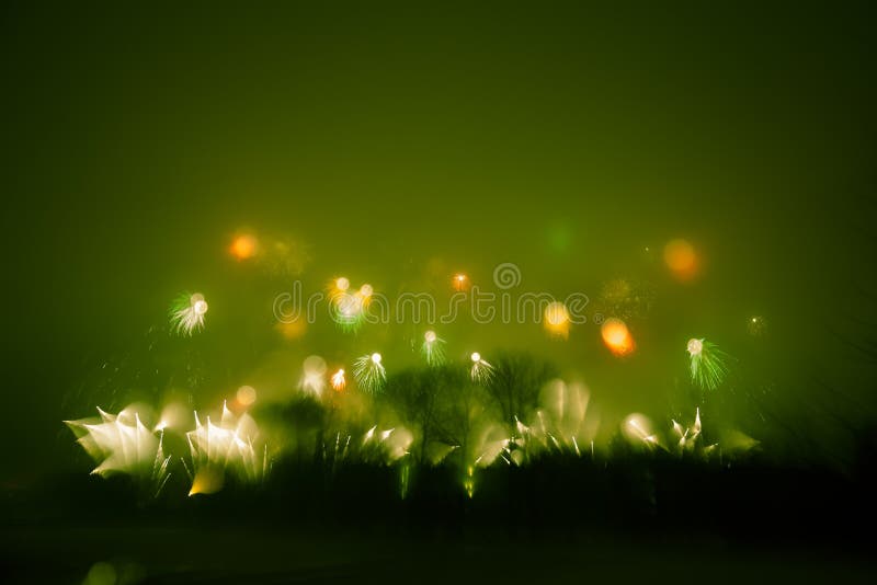 Abstract style colorful photo of fireworks in a green tone. Artistic, blurry, colorful look.