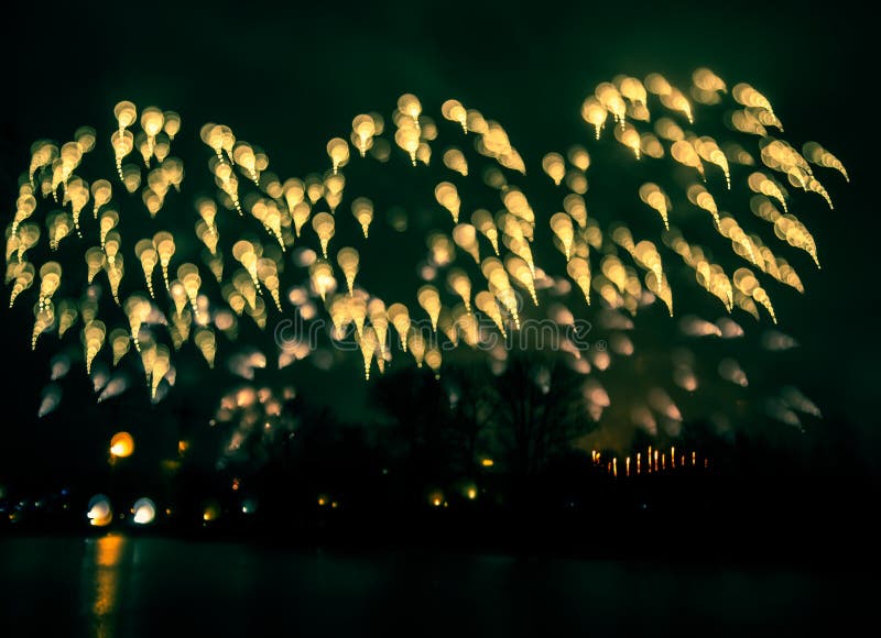 Abstract style colorful photo of fireworks in a green tone. Artistic, blurry, colorful look.