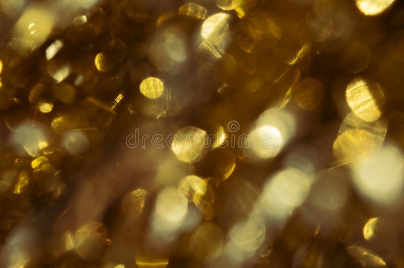 Abstract Texture with Gold Glitter Shimmering in the Sun. Light Stock