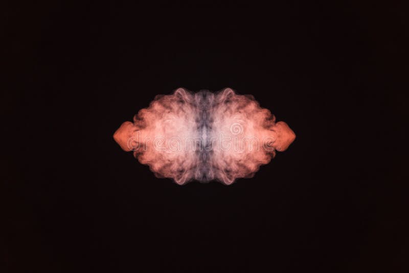 Abstract thick colored smoke on a black background with a monster face. The concept of light laser show at a musical concert and stock image Abstract thick colored smoke on a black background with a monster face. The concept of light laser show at a musical concert and stock image