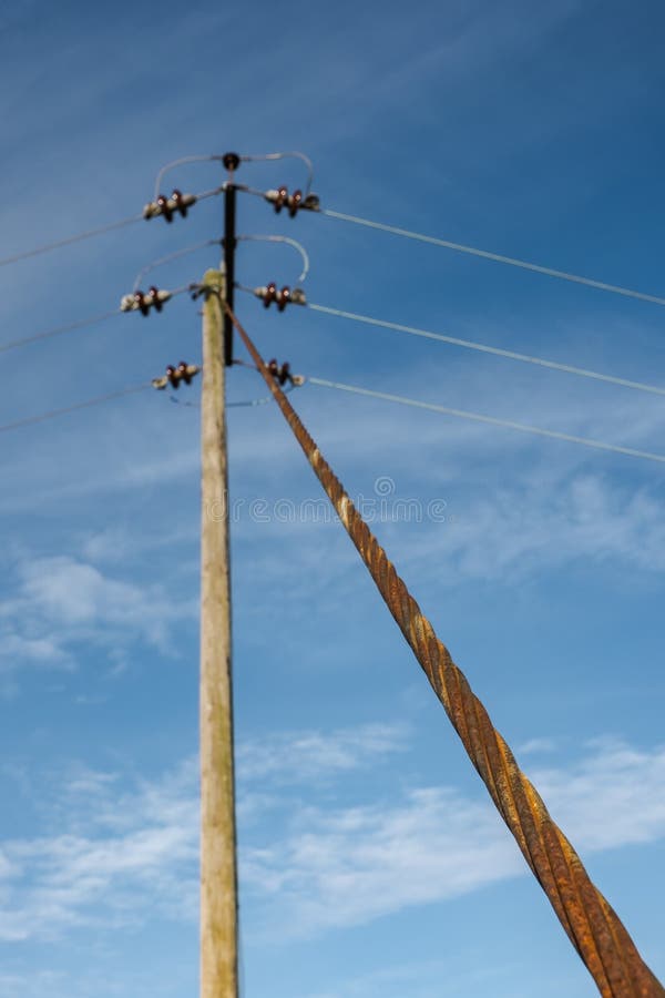 Abstract view of a high-voltage wooden pylon.