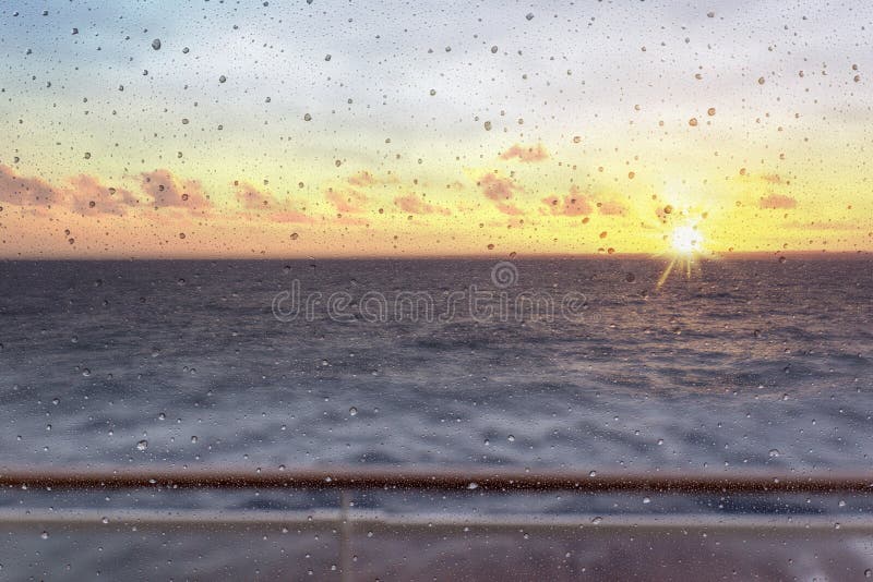 Abstract view of window droplets against setting sun and ocean stock photo Abstract view of window droplets against setting sun and ocean stock photo