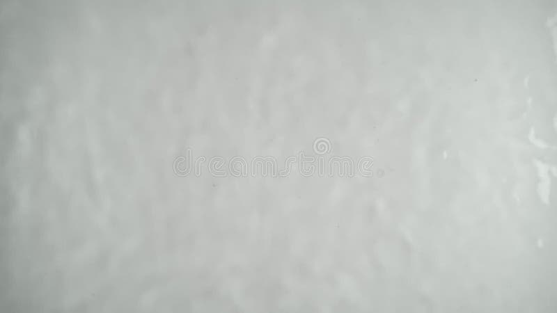 Abstract water waves in slow motion on a white background.