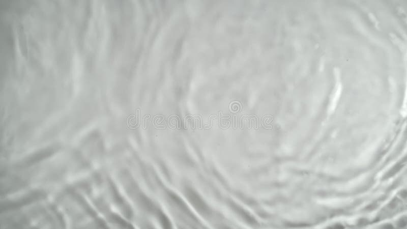 Abstract water waves in slow motion on a white background.