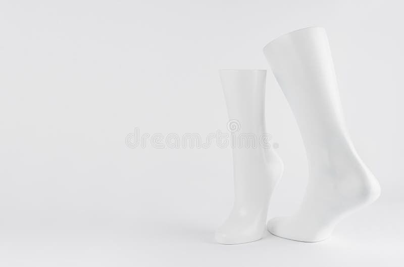 Abstract white modern statuette of two elegant white dancing legs on white background with copy space. royalty free stock photos