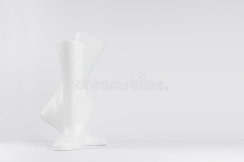 Abstract white modern statuette of two elegant white dancing legs on white background with copy space. royalty free stock photo