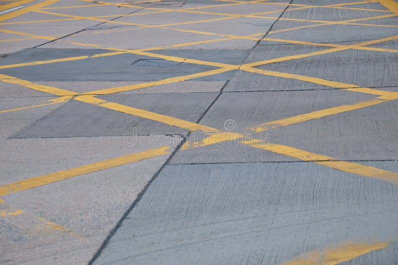 Abstract Yellow Painted Traffic Line Pattern on Concrete Road Street