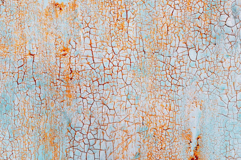 Abstracte blauwe oranje textuur met grungebarsten Gebarsten verf op een metaaloppervlakte