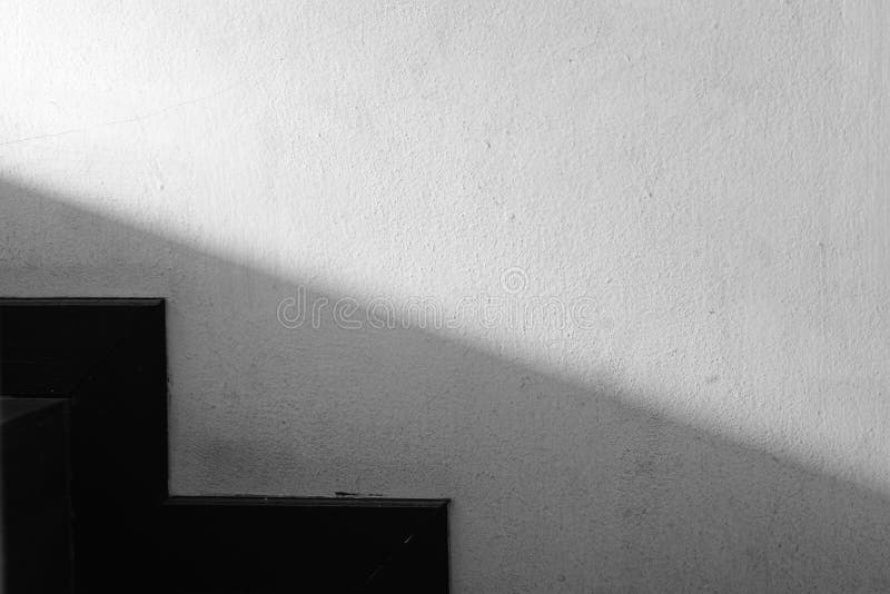 Abstracted light and shadow on the wall next to the stairs