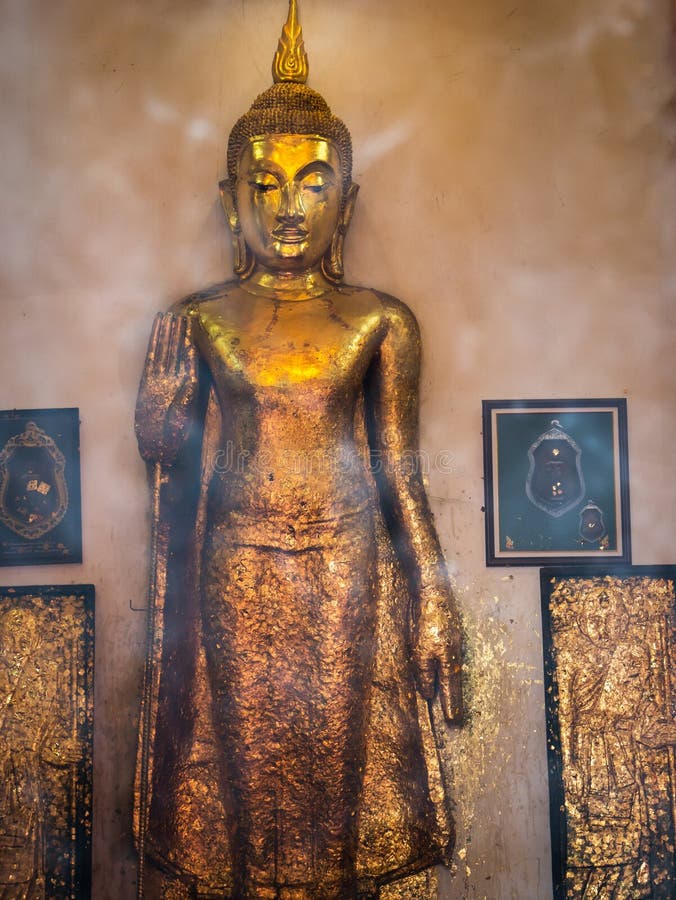 The Abstract of The Standing Buddha Statue with Holiness in The Temple. The Abstract of The Standing Buddha Statue with Holiness in The Temple