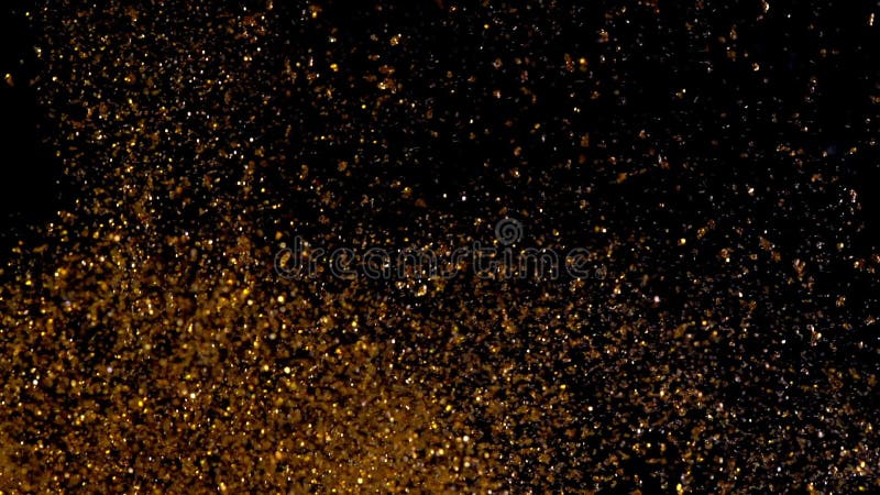 abstrakt härlig textur Guld- skina mousserar på svart Kopparpartiklar flyttar sig kaotiskt under vatten guld-