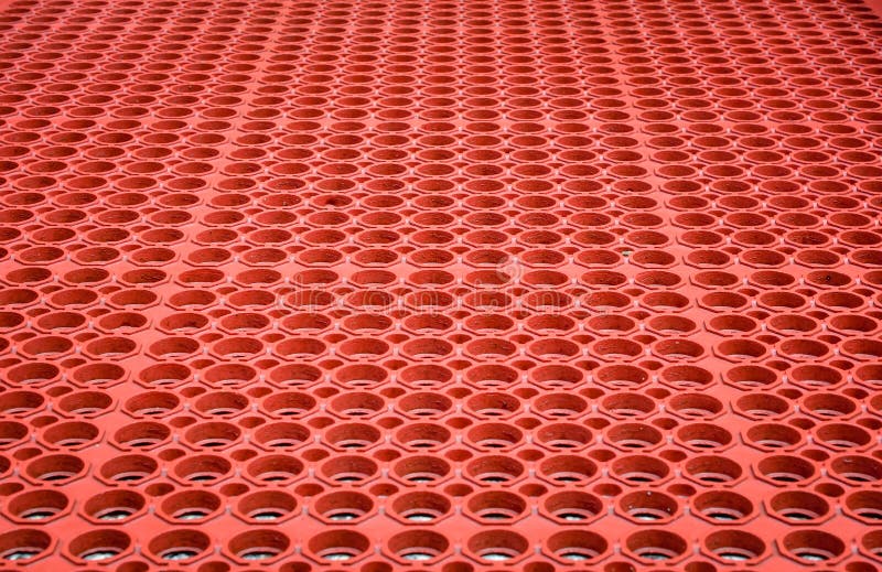 Abstrakt röd perforerad plast- bakgrund arkivbilder Abstrakt röd perforerad plast- bakgrund arkivbilder