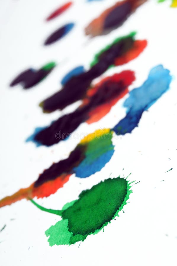 Abstract closeup photograph of colorful ink and paint splotches, splatters, dabs, dribbles, and splatters isolated on a white background. Shallow depth of field. Abstract closeup photograph of colorful ink and paint splotches, splatters, dabs, dribbles, and splatters isolated on a white background. Shallow depth of field.