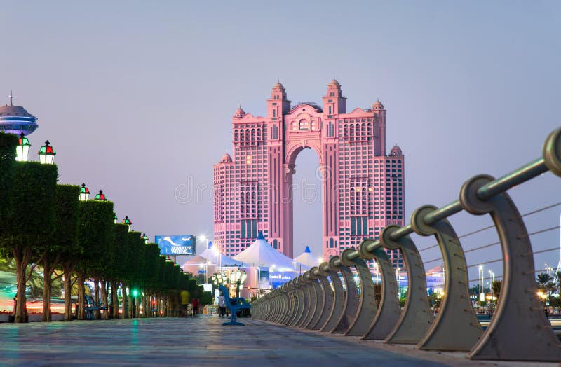 Abu Dhabi, United Arab Emirates - November 2, 2019: Al Marina island walking path by the seaside in Abu Dhabi at sunset, uae, mall, hotel, atlantis, fairmont, corniche, landmark, dbabi, background, object, view, luxury, sky, travel, water, modern, evening, dusk, architecture, building, center, city, exterior, urban, luxurious, tourism, town, famous, east, middle, editorial, arabic, venue, road. Abu Dhabi, United Arab Emirates - November 2, 2019: Al Marina island walking path by the seaside in Abu Dhabi at sunset, uae, mall, hotel, atlantis, fairmont, corniche, landmark, dbabi, background, object, view, luxury, sky, travel, water, modern, evening, dusk, architecture, building, center, city, exterior, urban, luxurious, tourism, town, famous, east, middle, editorial, arabic, venue, road