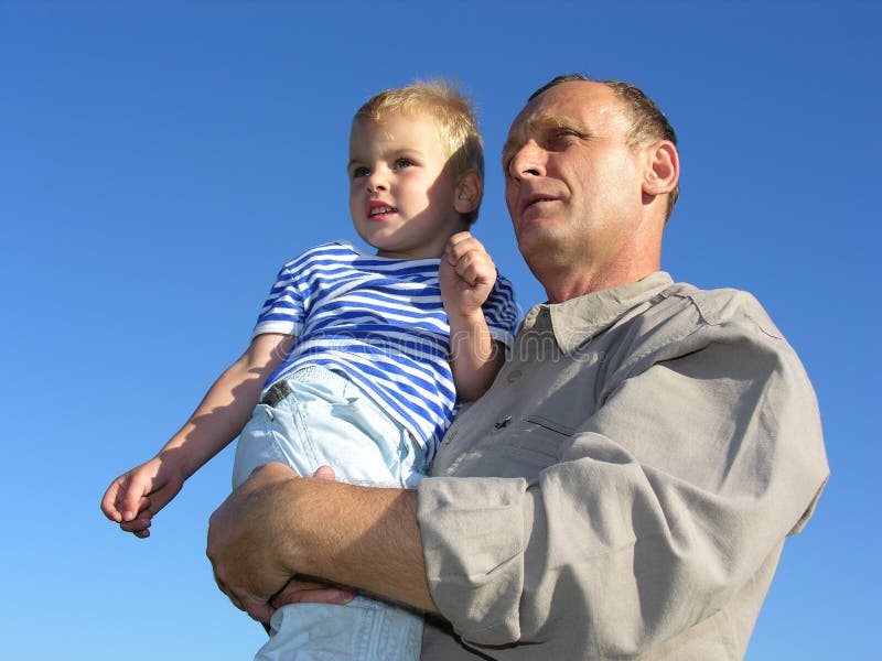 Grandfather with grandson look at horizon and future. Grandfather with grandson look at horizon and future