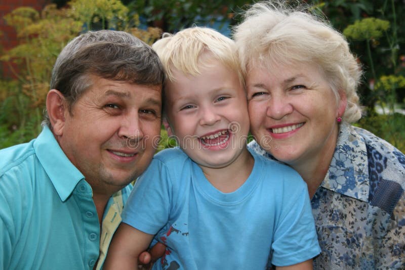 Smile grandparents with grandson in garden. Smile grandparents with grandson in garden