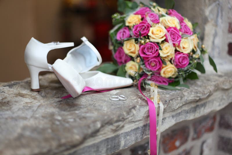 Wedding accessoires like rings, shoes, flowers and bouquet defocused. Wedding accessoires like rings, shoes, flowers and bouquet defocused
