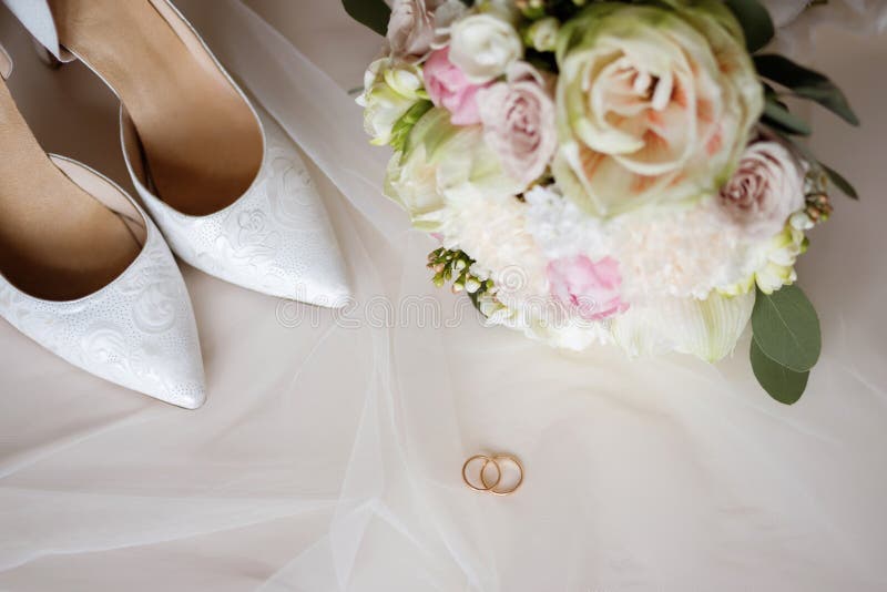 Women`s White Wedding Shoes with a Bouquet and Wedding Rings Stock ...