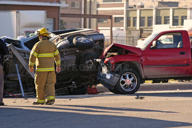 Car accident with a Fireman investigating the scene. Car accident with a Fireman investigating the scene