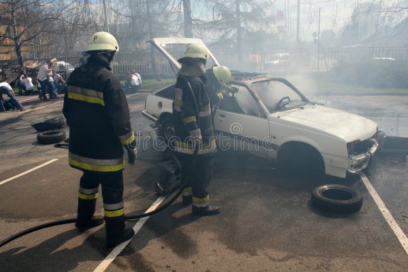 Fireman fighting fire after a car accident. Fireman fighting fire after a car accident