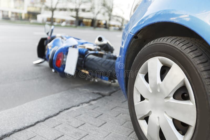 Accident motorcycle and cars on road