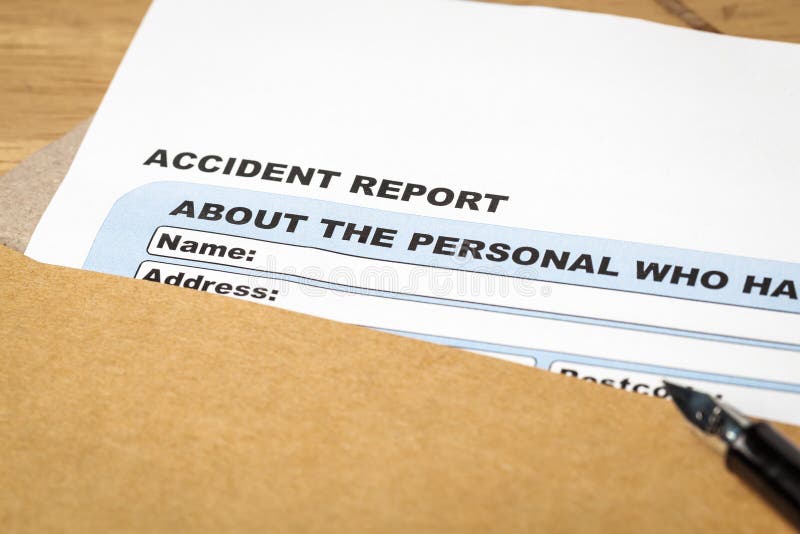 Accident report application form and pen on brown envelope, business insurance and risk concept; document is mock-up royalty free stock photography