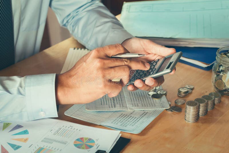 Accountant using calculator calculate budget for saving stock images
