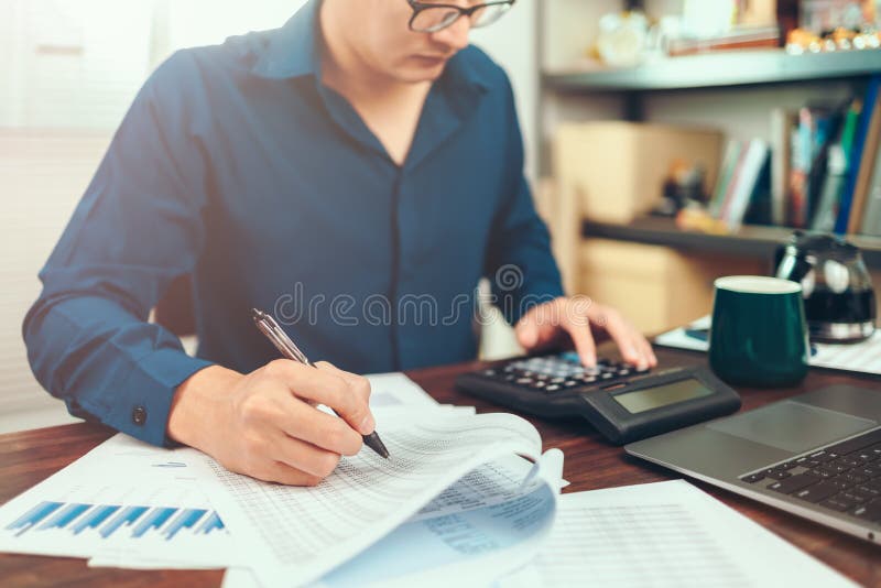 Accounting Woking with Data Sheet on the Office Desk. Calculator with