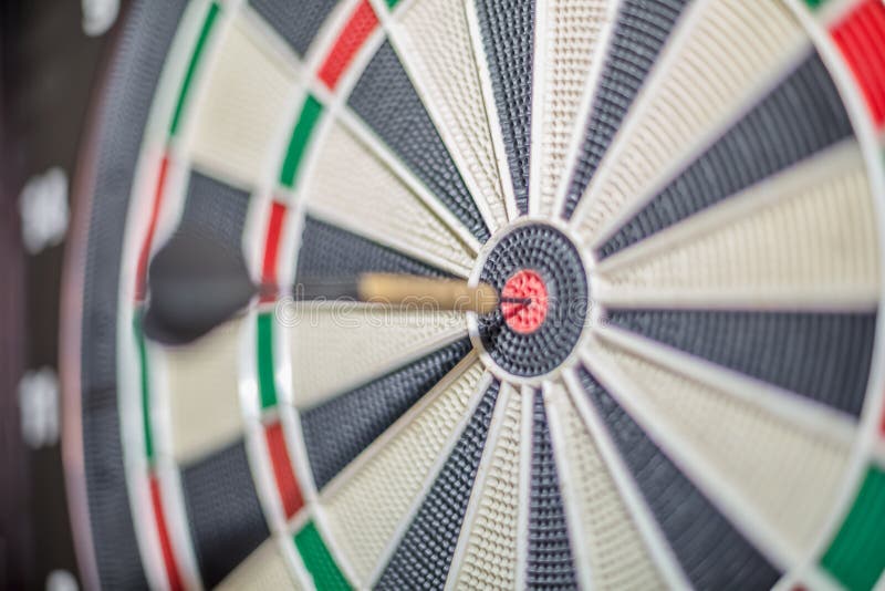 Accurate dart sight hitting center of target, dartboard and dart, blurred background stock images Accurate dart sight hitting center of target, dartboard and dart, blurred background stock images