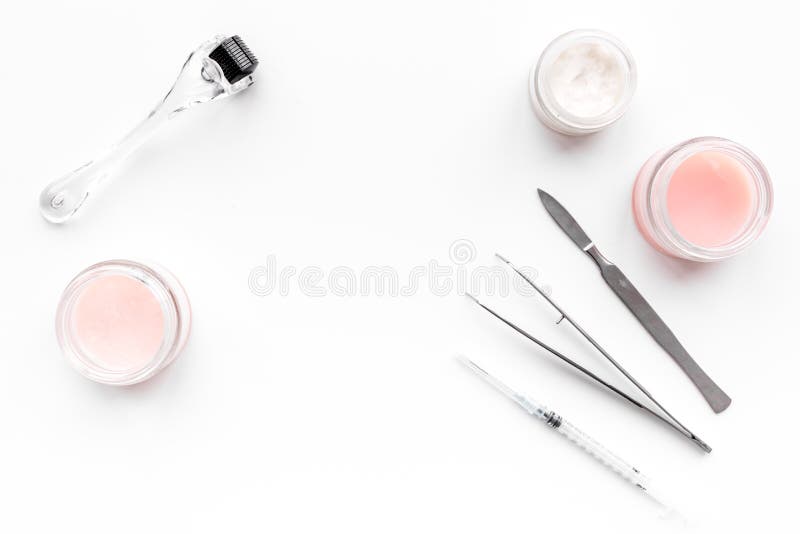 Acessórios do dermatologista ou do cosmetologist Dermaroller, desnata e máscara, injeção da beleza, ferramentas no fundo branco imagem de stock Acessórios do dermatologista ou do cosmetologist Dermaroller, desnata e máscara, injeção da beleza, ferramentas no fundo branco imagem de stock