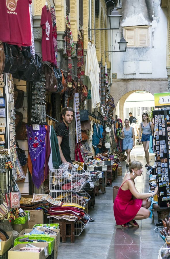 Tourists shopping in the Souk of Granada on a sunny day. It is an editorial image in vertical. Tourists shopping in the Souk of Granada on a sunny day. It is an editorial image in vertical.