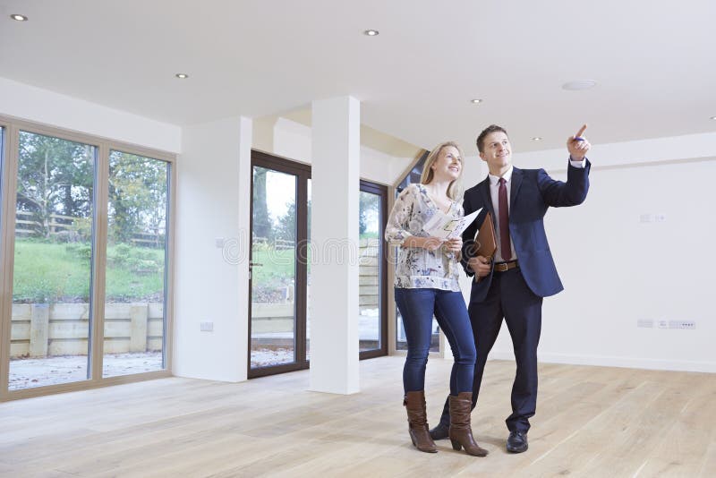 Estate Agent Showing Prospective Buyer Around Property. Estate Agent Showing Prospective Buyer Around Property