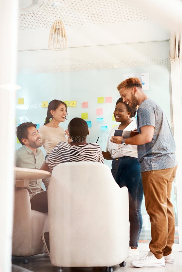 Achieving Bigger Goals Together. a Group of Young Creatives Working Together in an Office. Stock