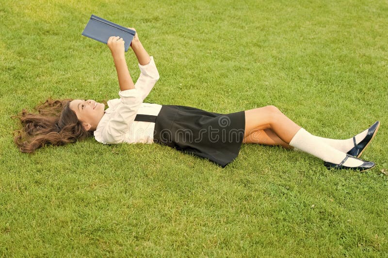Achieving Excellence. small girl reading book. literature for kids. write childhood memories. her diary. making notes in stock image