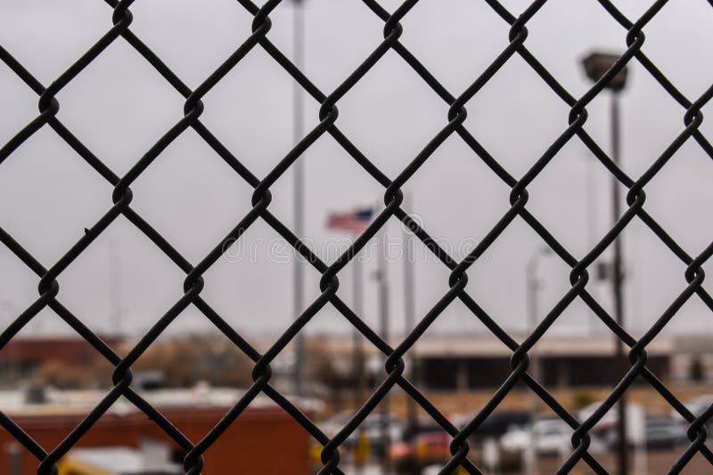 Border crossing, with unfocused background, cars, flag, cloudy day, mexico, jail, migration, security, hope, locked, detention, U.S, picture Photography, Dark, blur, shallow depth of field, a cloudy day on the border of Mexico and the United States. Border crossing, with unfocused background, cars, flag, cloudy day, mexico, jail, migration, security, hope, locked, detention, U.S, picture Photography, Dark, blur, shallow depth of field, a cloudy day on the border of Mexico and the United States