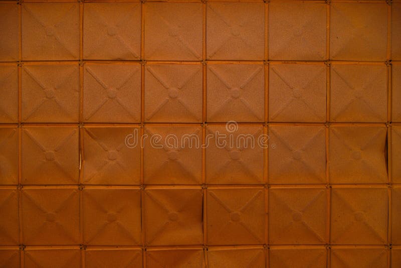 full-frame background and texture of square stamped sheet metal tiles with diagonal ribs. full-frame background and texture of square stamped sheet metal tiles with diagonal ribs.