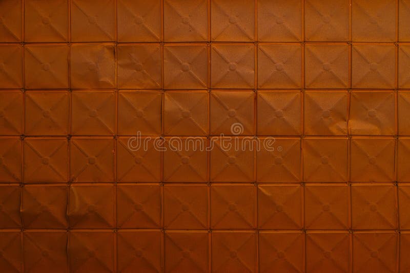 full-frame background and texture of square stamped sheet metal tiles with diagonal ribs. full-frame background and texture of square stamped sheet metal tiles with diagonal ribs.