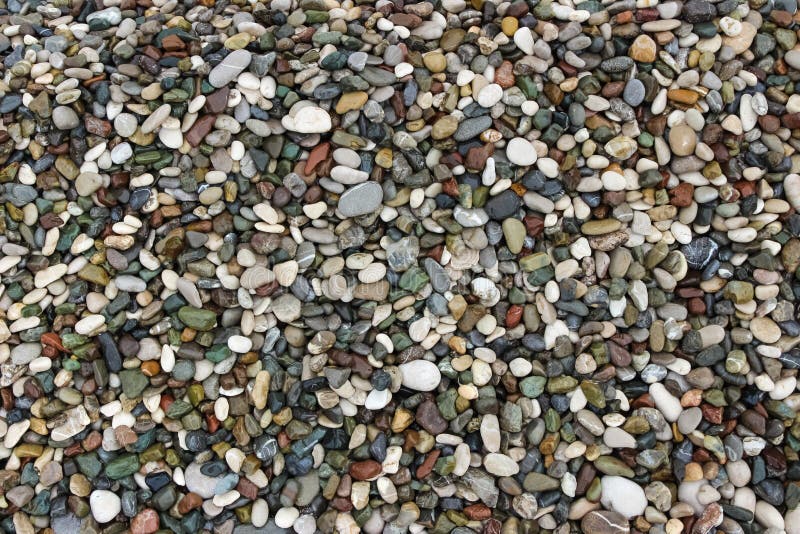 Achtergrond van het kleine strand van de stenenkiezelsteen stock afbeeldingen Achtergrond van het kleine strand van de stenenkiezelsteen stock afbeeldingen