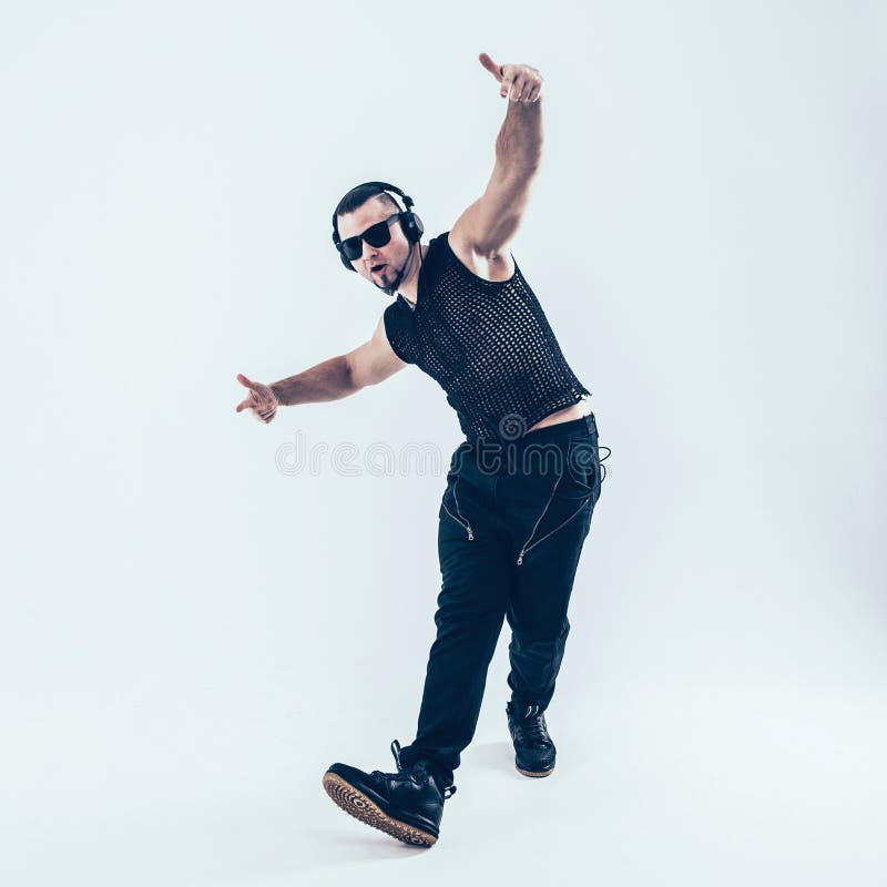 Creative rapper in the headphones and dark glasses performs a rap song .photo on a white background and has an empty space for your text. Creative rapper in the headphones and dark glasses performs a rap song .photo on a white background and has an empty space for your text