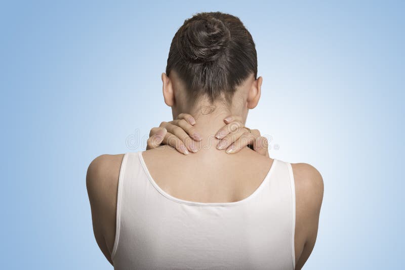 Back and spine disease. Closeup back view tired female massaging her painful neck isolated on blue background. Back and spine disease. Closeup back view tired female massaging her painful neck isolated on blue background