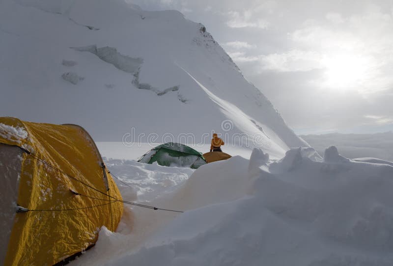 Above the clouds. Evening in the high-altitude mountaineering camp at North of Khan Tengri peak, Camp 2 (5,500 m or 18,000 ft), Tian Shan mountains, Cental Asia, Kazakhstan, Kyrgyzstan. Above the clouds. Evening in the high-altitude mountaineering camp at North of Khan Tengri peak, Camp 2 (5,500 m or 18,000 ft), Tian Shan mountains, Cental Asia, Kazakhstan, Kyrgyzstan